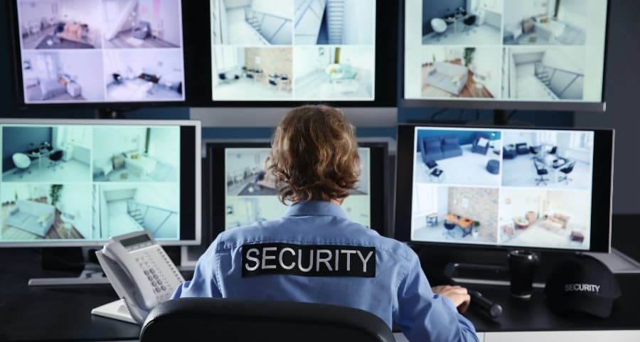 Security professional monitoring surveillance footage