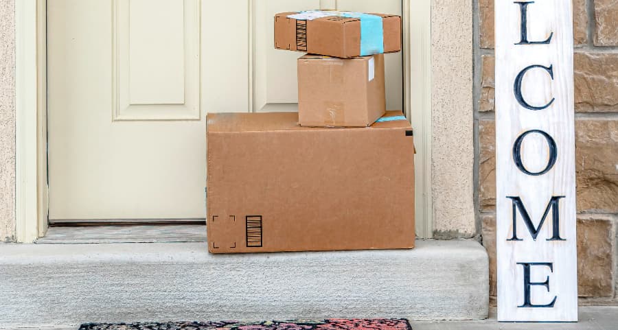 Packages on the doorstep of a home with a welcome sign in Tempe